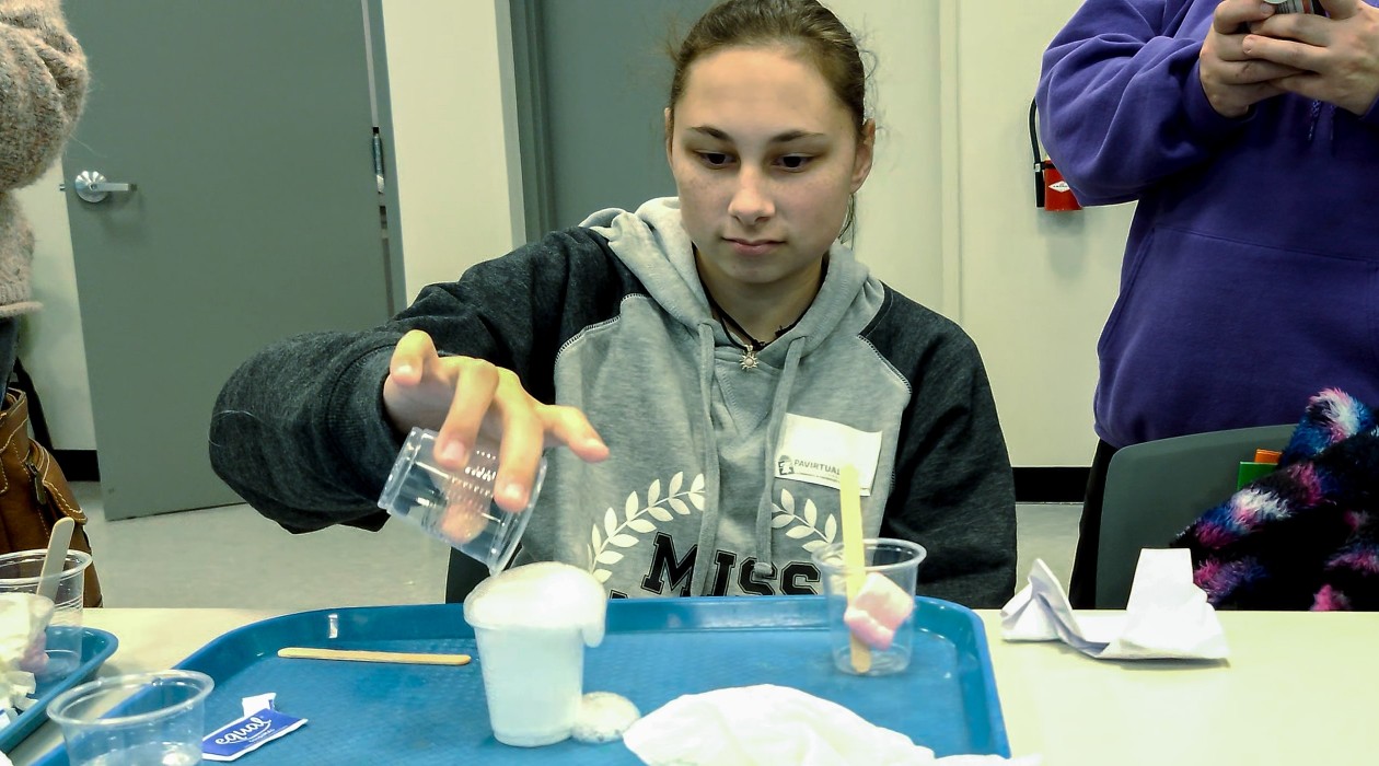 A female sophomore performs an experiment at the Whittaker Center