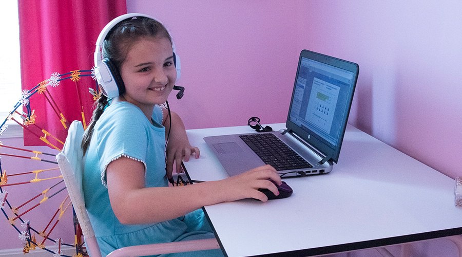 PA Virtual student wears headset and attends class from her laptop