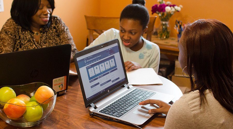 PA Virtual parent sits with her children as they complete schoolwork