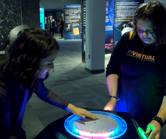 student and staff at science center
